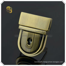 brushed antique brass press bag lock with key